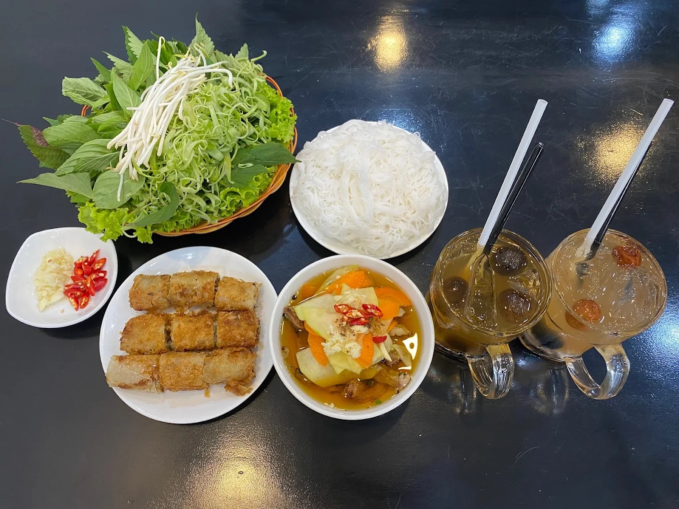 The bun cha is prepared in true Hanoi style, from the dipping sauce to the grilled pork and crispy spring rolls 